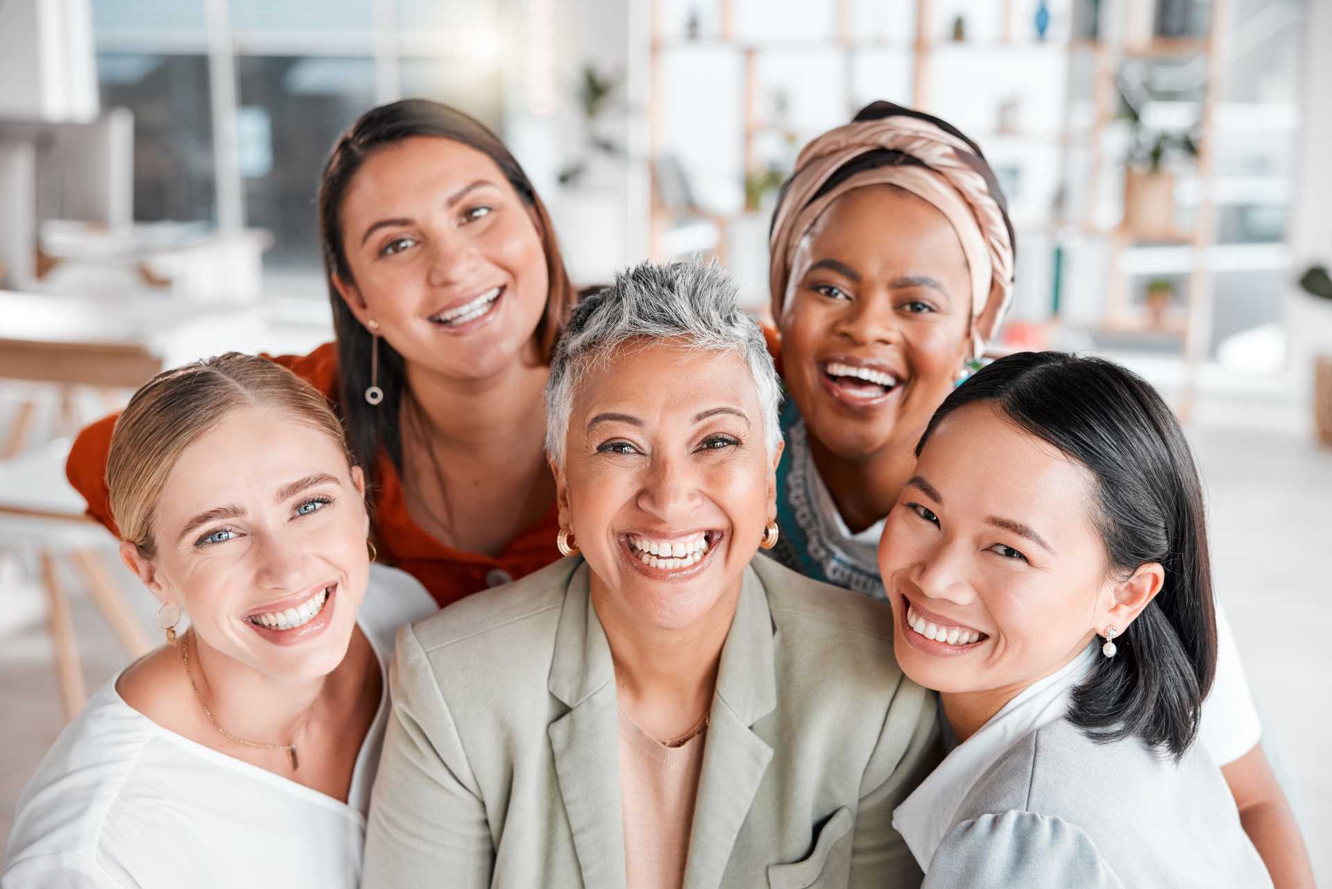 Group of women smiling | Featured image for the Women’s Dental Health blog by Pearl Denture Studio.